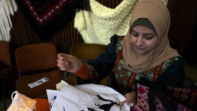 A Palestinian woman prepares Ramadan decorations. AFP