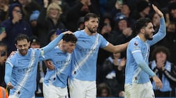 Manchester City's Phil Foden, second left, celebrates with Bernardo Silva, Ruben Dias and Rayan Cherki after scoring the third goal against Sunderland. AFP