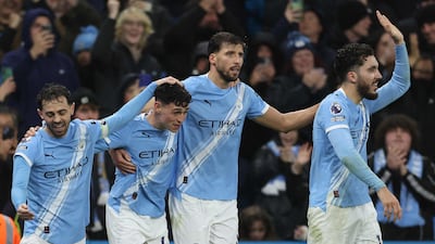 Manchester City's Phil Foden, second left, celebrates with Bernardo Silva, Ruben Dias and Rayan Cherki after scoring the third goal against Sunderland. AFP