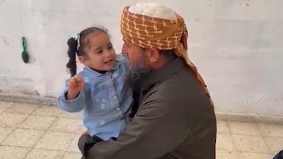 Khaled Nabhan with granddaughter Reem. Friends suggest the Gaza community worker with a 'resilient' spirit may not have been a random victim of Israeli bombing. Photo: Khaled Nabhan