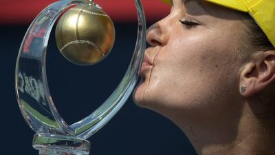 Agnieszka Radwanska of Poland kisses the winner's trophy after beating Venus Williams of the United States in the final at the Rogers Cup in Montreal. Paul Chiasson / AP Photo