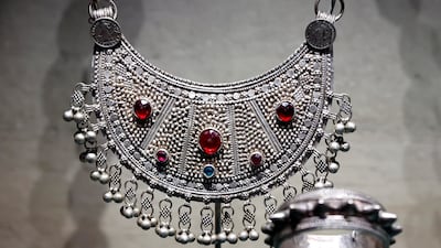 The crescent-shaped necklace, made in Ajman in the 1950s, reflects the jewellery and objects through which women’s lives, status and traditions are explored in Women of the Nation. Victor Besa / The National