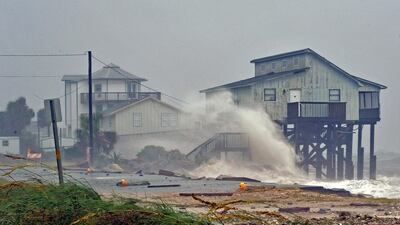 Waves crash against stilt houses along the shore at Alligator Point in Franklin County, Florida. Reuters