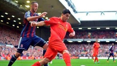 Luis Suarez, second right, the Liverpool striker, endured another frustrating afternoon at Anfield. Paul Eliis / AFP