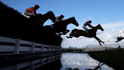 CHELTENHAM, ENGLAND - MARCH 14: Runners take the water jump during the Ultima Handicap Chase during day one of the Cheltenham Festival 2023 at Cheltenham Racecourse on March 14, 2023 in Cheltenham, England. (Photo by Michael Steele / Getty Images)