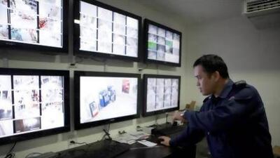 A security guard at Al Wahda Mall monitors CCTV cameras. Sammy Dallal / The National