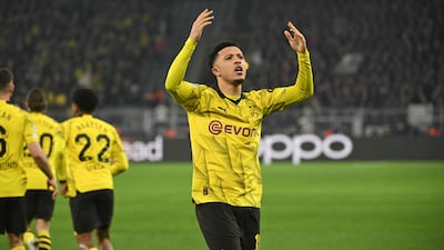 Jadon Sancho celebrates in front of the fans after scoring for Dortmund against PSV. AFP