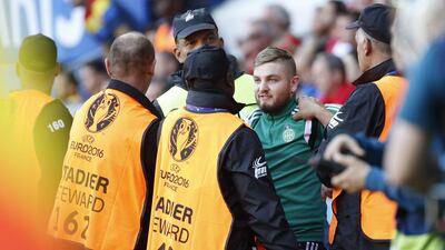 Stewards remove a pitch invader during the UEFA EURO 2016 group A preliminary round match between Romania and Switzerland at Parc de Princes in Paris, France, 15 June 2016. EPA/YOAN VALAT