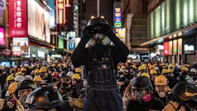 A protester uses binoculars during a stand-off with police on August 3, 2019 in Hong Kong, China. Getty