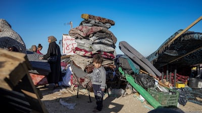 Displaced Palestinians arrive in central Gaza after fleeing from the southern Gaza city of Rafah in Deir al Balah, Gaza Strip, on May 8, 2024. AP