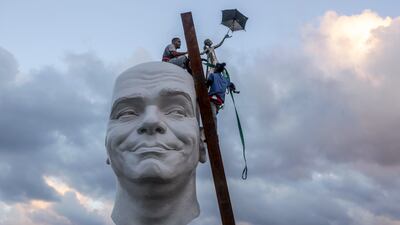 Workers install a piece by artist Osmany Betancourt as part of 15th Havana Biennial, in Havana, Cuba, Friday, Dec. 6, 2024. (AP Photo / Ariel Ley)