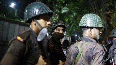 Bangladeshi security personnel stand guard near a restaurant in the diplomatic zone of Dhaka, Bangladesh,on July 1, 2016. Gun attacked the restaurant , which is popular with foreigners and locals and took hostages. Associated Press