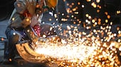 Welder polishes raw metal at a manufacturing company in Hangzhou, in eastern China's Zhejiang province. AFP