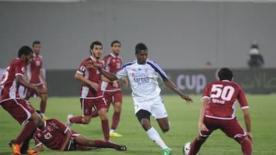 Asamoah Gyan, centre, scored twice during Al Ain’s 4-1 win over Al Wahda on Friday night.