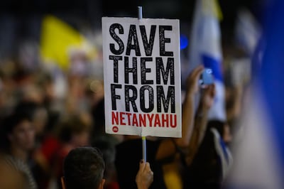A demonstrator holds a placard calling for the return of the hostages believed to be held in Gaza on October 5, 2024 in Tel Aviv. Getty Images