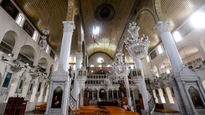 The interior of the Mariamite Cathedral of Damascus, one of the oldest Greek Orthodox churches in the Syrian capital. The hole in its roof was caused by a mortar shell during a rebel bombardment in the eastern Bab Touma neighbourhood in February. AFP