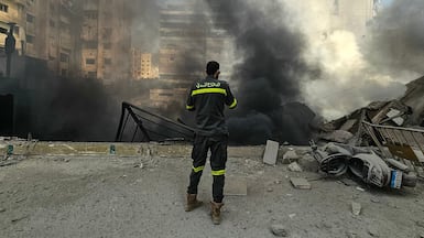 A civil defence worker at the site of overnight Israeli air strikes in the southern suburbs of Beirut, Lebanon. AFP