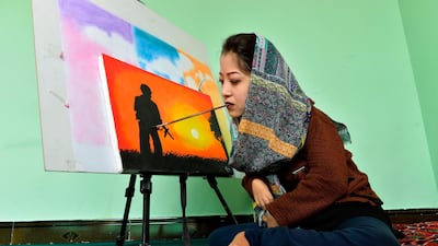 19-year-old Afghan artist Robaba Mohammadi painting in her studio in Kabul. Unable to use her hands, arms, or legs, Afghan artist Robaba Mohammadi has defied unlikely odds in a country that routinely discriminates against women and disabled people. AFP