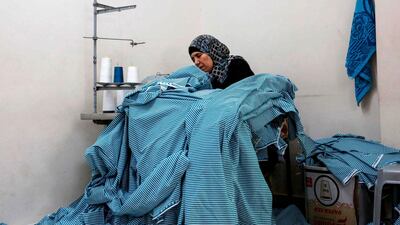 Cloth is gathered together before sewing and cutting begins. AFP