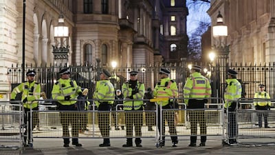 British police officers outside Downing Street in London. PA via AP