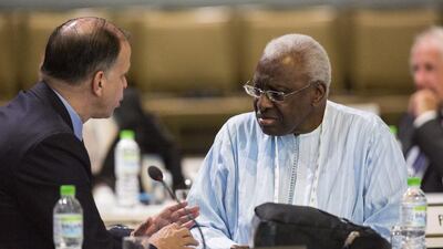 International Association of Athletics Federations president Lamine Diack, right, speaks with a fellow International Olympic Committee member during the 128th IOC session in Kuala Lumpur, Malaysia, on August 3, 2015. Joshua Paul / AP Photo