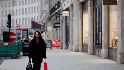 A pedestrian walks along a near-deserted street in central London on Black Friday. AFP