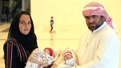 Nehal Manoun with month-old Zayed and Altaf Hussein with Khalifa. Satish Kumar / The National