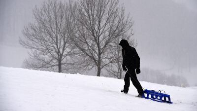 A man pulls a sleigh in Dietges. AFP