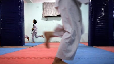 Afghan Taekwondo club members warm up ahead of their practice session in Kabul. AP
