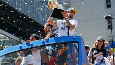 Golden State Warriors guard Stephen Curry holds up the Larry O'Brien NBA Championship Trophy. John G. Mabanglo / EPA