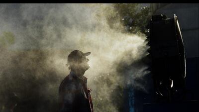 A spectators cools off in front of misting fans at the Australian Open. Narendra Shrestha / EPA