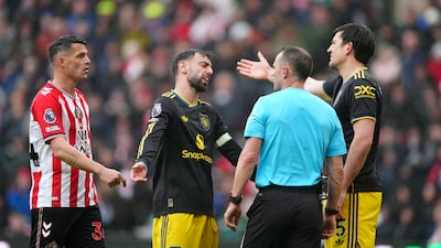 Manchester United's Bruno Fernandes and Harry Maguire speak to referee Stuart Attwell. PA