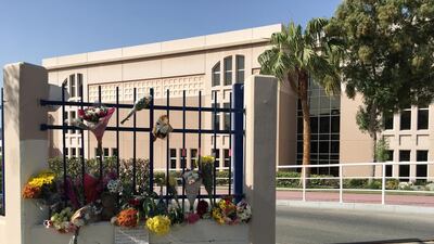 Flowers have been left outside the gates of the school. Antonie Robertson / The National