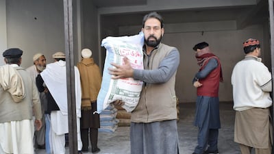 MrJan holding a bag of flour. Pakistan is gripped by a wheat flour crisis, that has seen prices rise to unaffordable levels.