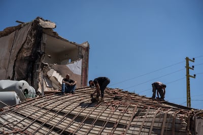 People work to repair a building damaged by an Israeli strike in Tyre, south Lebanon. Getty Images