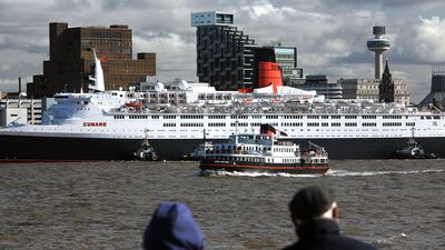 The soon-to-be-decommissioned QE2 liner docks in front of the Liver building on the Mersey during her farewell voyage in October 2008 in Liverpool, England. Getty Images