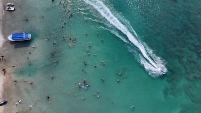 A man riding a jet-ski as people from Latakia and other parts of Syria gather at the beach in the coastal Mediterranean city of Latakia. AFP