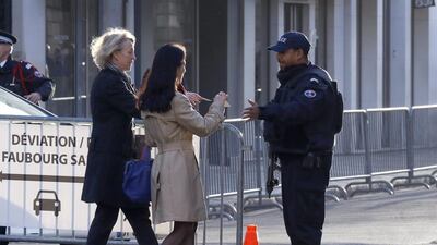 A police officer checks identity documents to enter the perimeter of the Elysee Palace, or presidential residence, in Paris. The Paris prosecutor’s office said Wednesday that SWAT teams have arrested three people in an apartment in Saint-Denis, outside Paris, where police are in a standoff with suspects from last week’s Paris attacks. Jacques Brinon / AP
