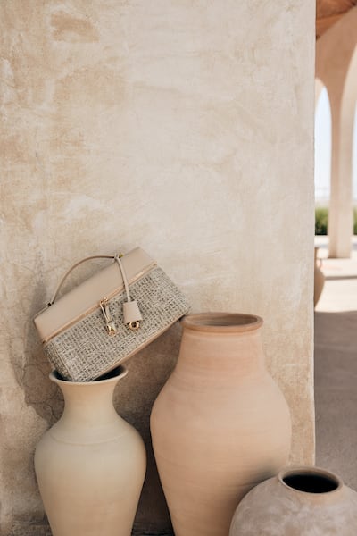 The Extra Pocket pouch woven from cotton and wool in beige, light moss and gold. Photo: Loro Piana