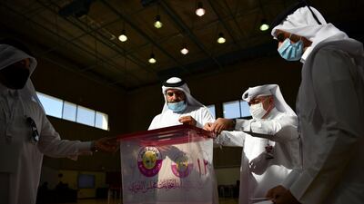 Qatari men cast their votes. Reuters