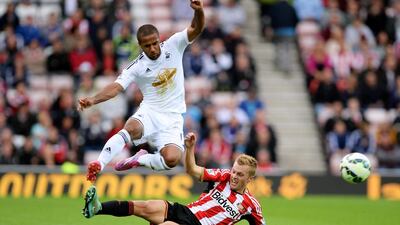 Wayne Routledge of Swansea City hurdles the challenge from Sebastian Larsson of Sunderland during their Premier League match on Saturday. Nigel Roddis / Getty Images