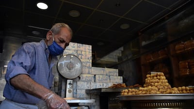 A Syrian readies Arabic sweets at Al Marjeh market ahead of Eid in the old city of Damascus, Syria, May 21. Youssef Badawi/ EPA