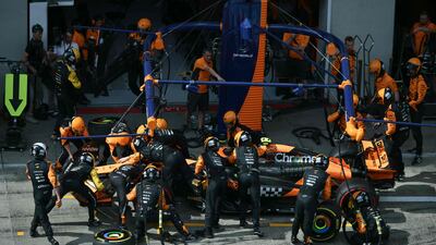 McLaren's Lando Norris stands in the pit after colliding with Red Bull driver Max Verstappen. AFP