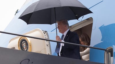 US President Donald Trump and first lady Melania Trump disembark from Air Force One at Newark Liberty International Airport on July 14, 2017. Mr Trump returned home from France to more media revelations about his eldest son's meeting with a Kremlin-connected lawyer during his election campaign in 2016. Carolyn Kaster / AP Photo