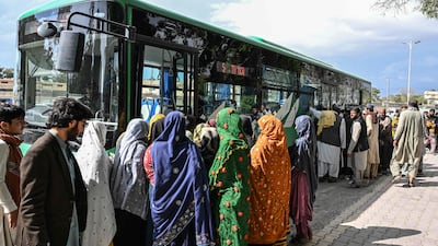 Commuters board a bus in Quetta, Pakistan, which has been affected by the economic fallout from the Iran war. AFP