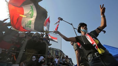 A demonstrator waving a national flag flashes the victory sign near al-Jumhuriya bridge. AFP