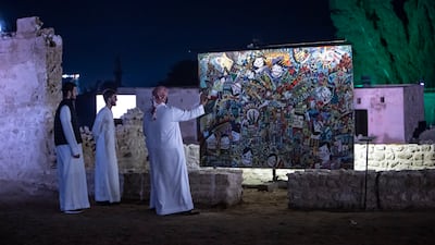 Visitors admire an artwork on opening night