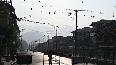 A security personnel stands guard at a roadblock during a curfew in Srinagar. India's home affairs minister on August 6 hailed "historic" legislation to bring Kashmir under its direct control, as New Delhi stepped up its clampdown on dissent in the restive Muslim-majority region. AFP
