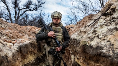 A Ukrainian sniper with the 28th Brigade moves to a fighting position in a front-line trench facing Russian troops in March 2023 outside of Bakhmut. Getty Images