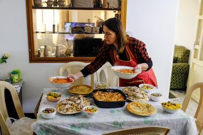 A woman in Mosul, Iraq sets the table for family, on February 21, 2021. Across the Middle East, daily cooking is still predominantly seen as a woman's task. Reuters